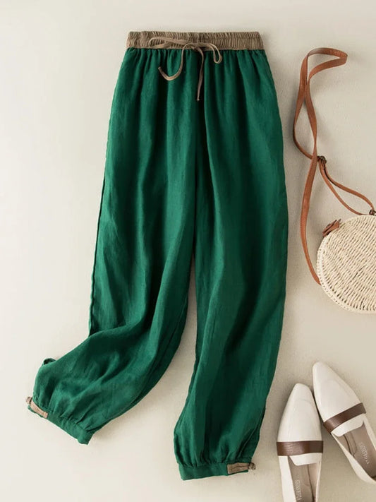 Loose green ankle-length pants with elastic waistband made of breathable cotton-linen blend for comfortable active living.